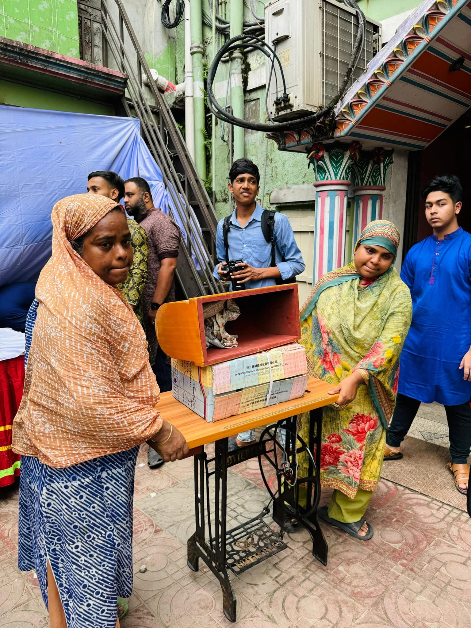 A sewing machine being presented to a woman
