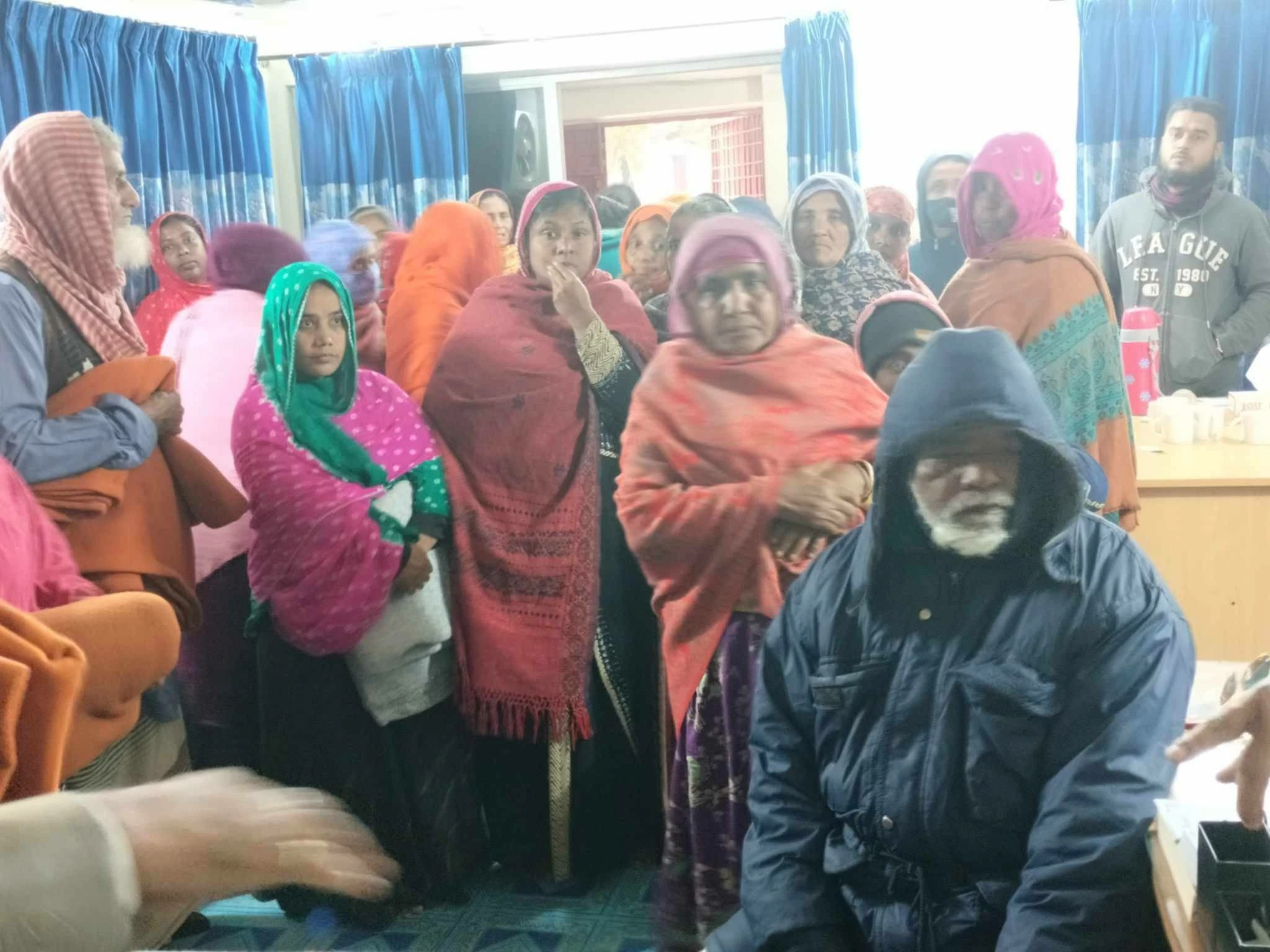 People gathered with blankets indoors