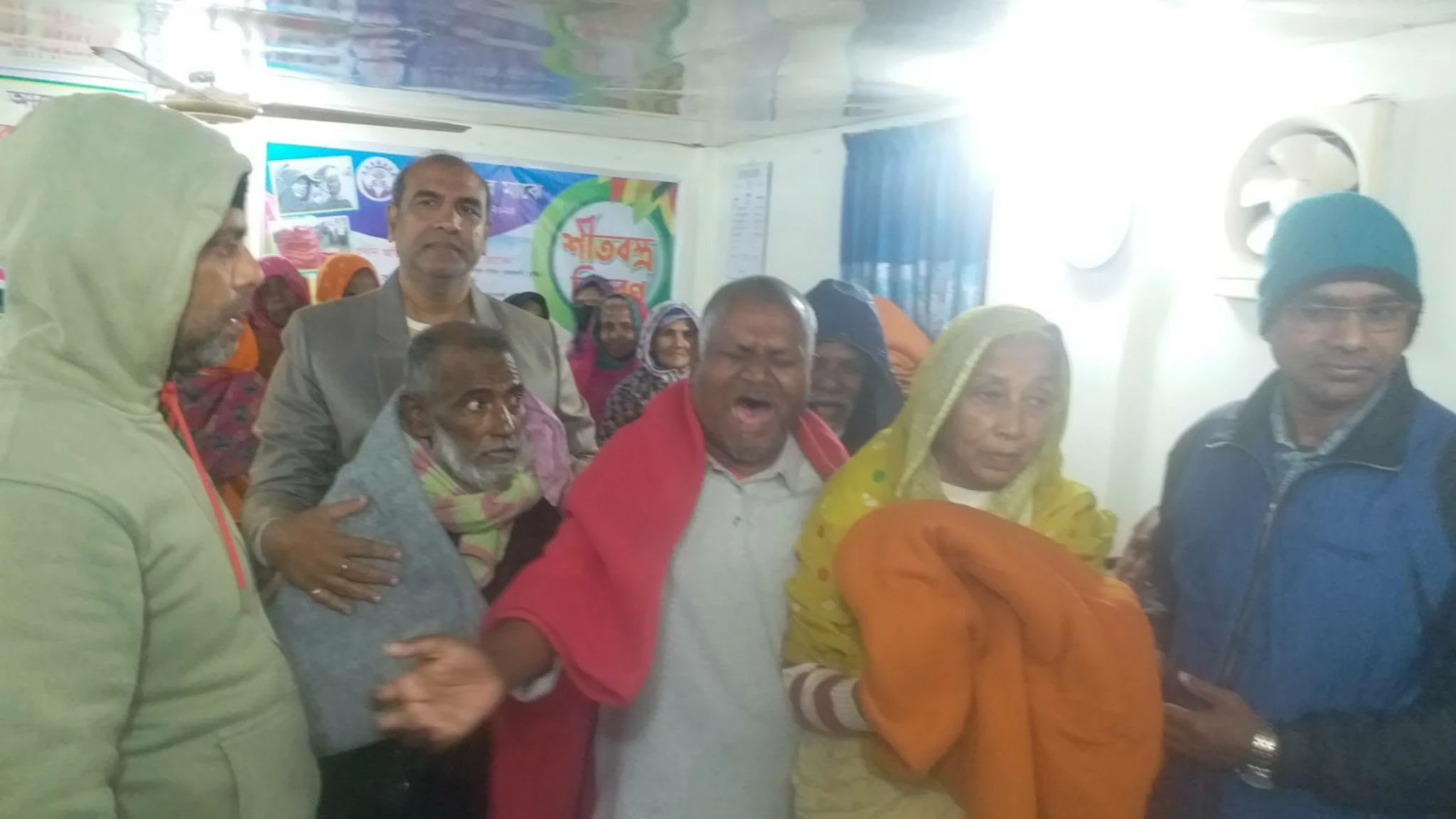 A group at an indoor blanket distribution